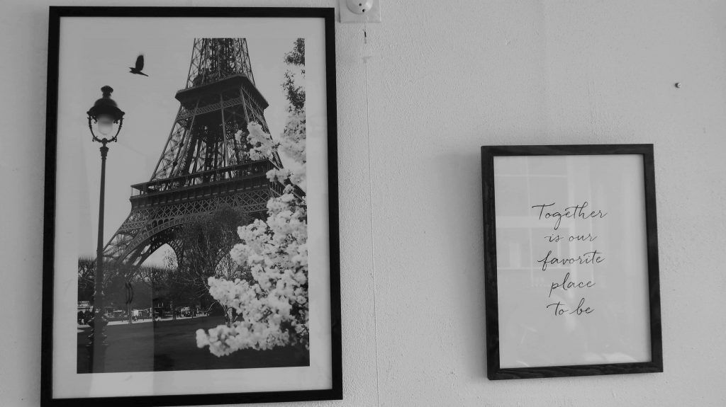 A Photo Wall In The Bedroom With Posters From Poster Store